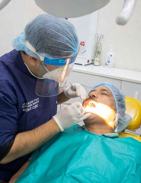 Dr. Rudraksh Treating the patient-Best Dentist in Haldwani